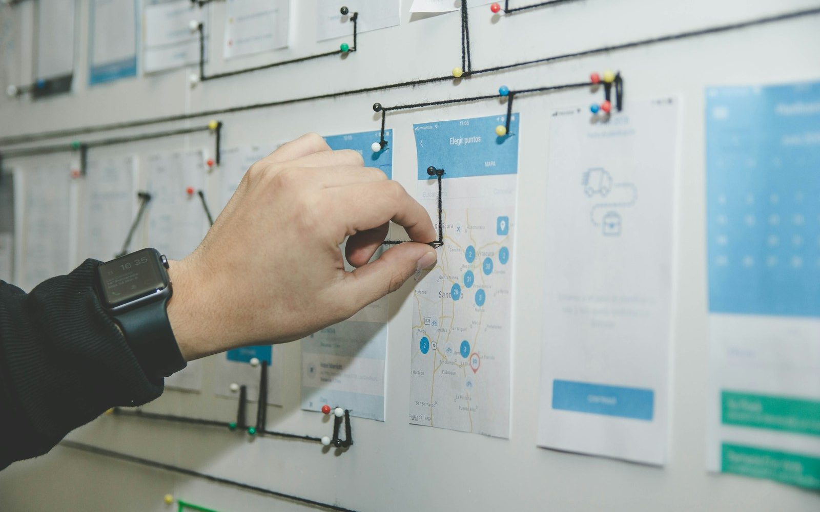 person working on blue and white paper on board